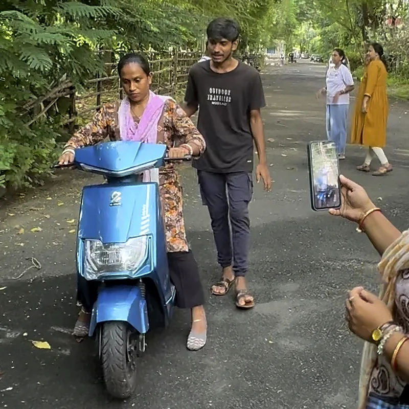 Family filming a learner’s ride on a quiet lane near home